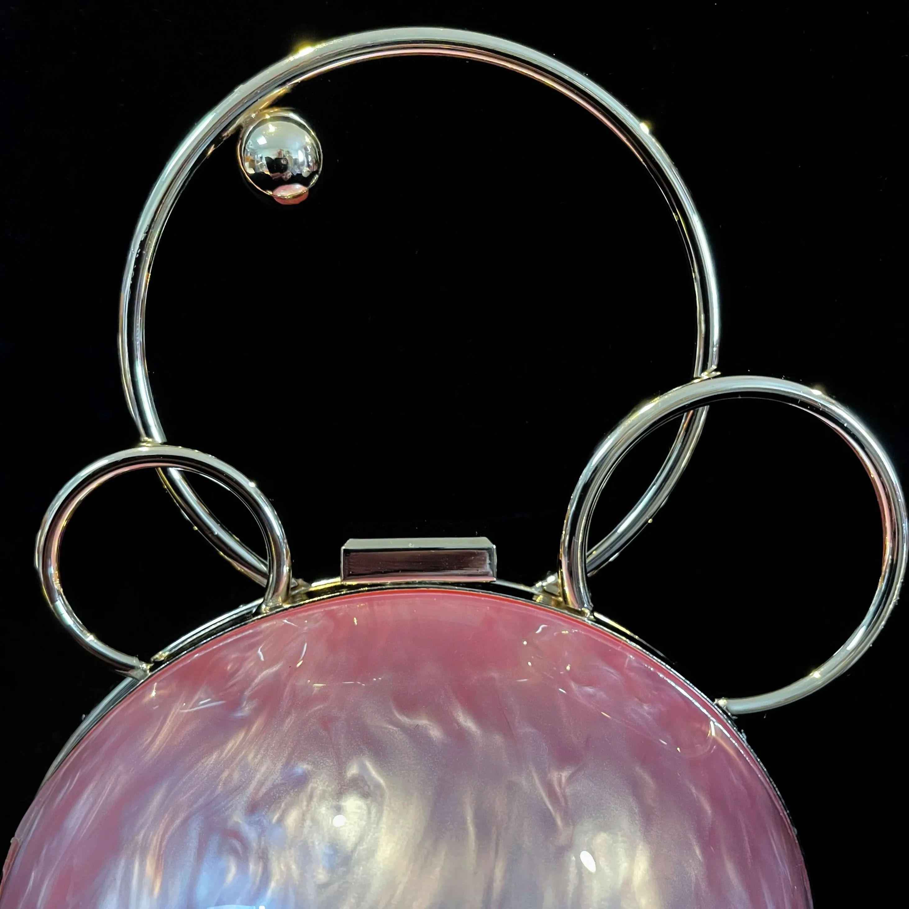A PERSPEX ORBIT BAG WITH GOLD FITTINGS