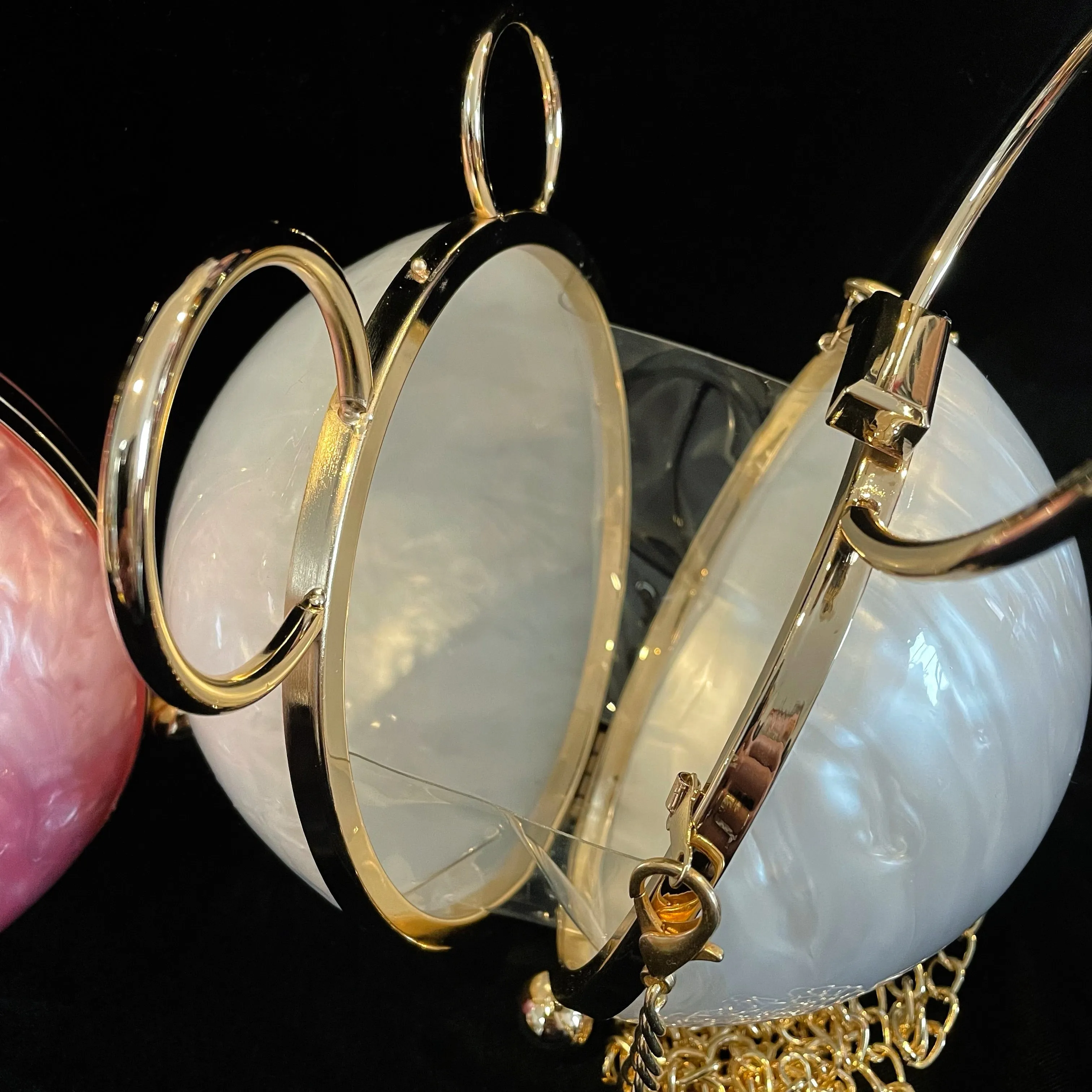 A PERSPEX ORBIT BAG WITH GOLD FITTINGS
