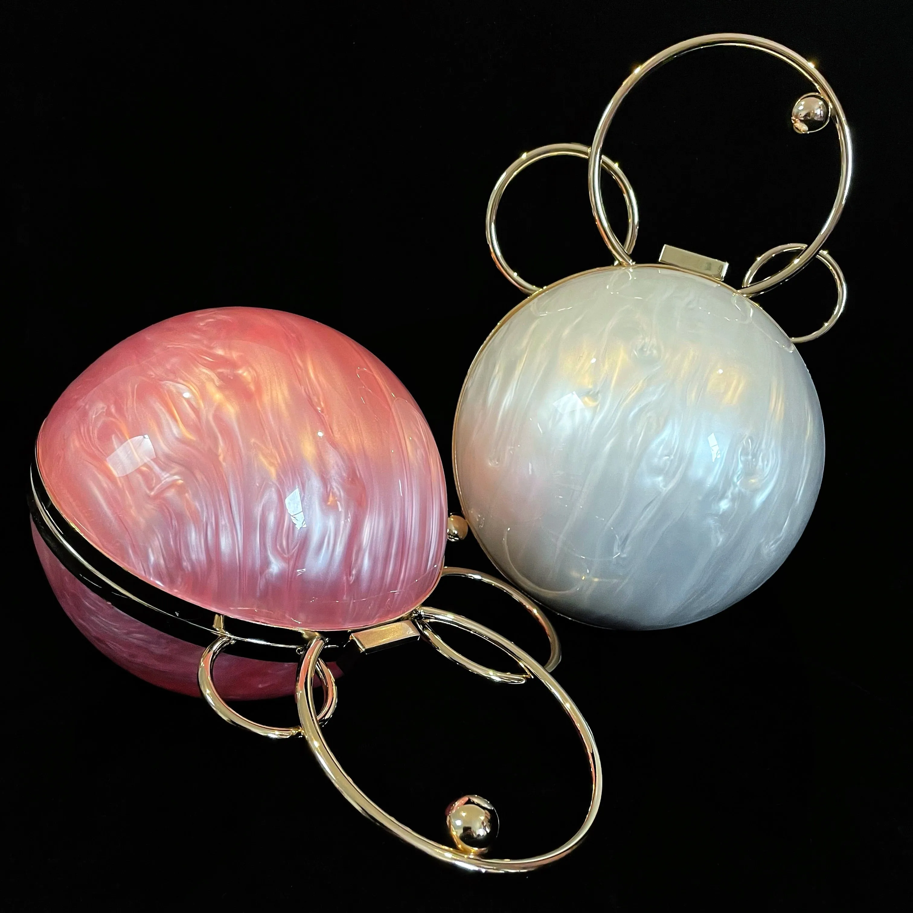 A PERSPEX ORBIT BAG WITH GOLD FITTINGS