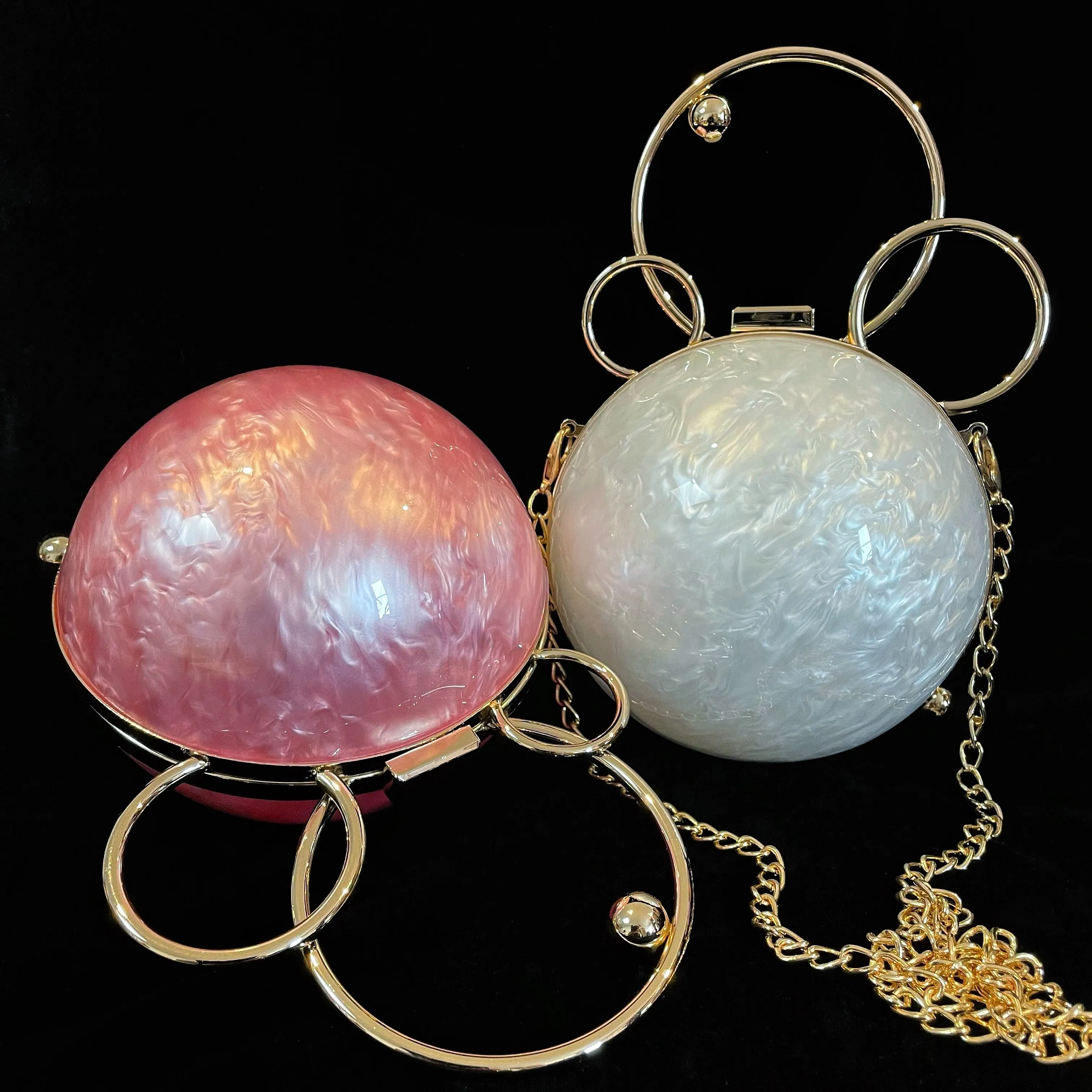 A PERSPEX ORBIT BAG WITH GOLD FITTINGS
